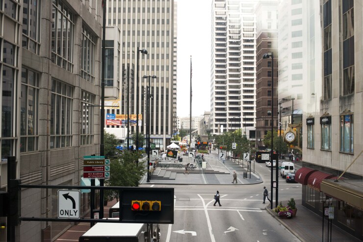 People walk through the streets of downtown Cincinnati, Ohio.