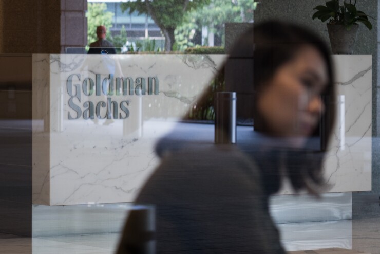 The Goldman Sachs Group Inc. logo is displayed in the reception area of the One Raffles Link building, which houses one of the Goldman Sachs (Singapore) Pte offices, in Singapore, on Saturday, Dec. 22, 2018. Singapore has expanded a criminal probe into fund flows linked to scandal-plagued 1MDB to include Goldman Sachs Group, which helped raise money for the entity, people with knowledge of the matter said. Photographer: Nicky Loh/Bloomberg