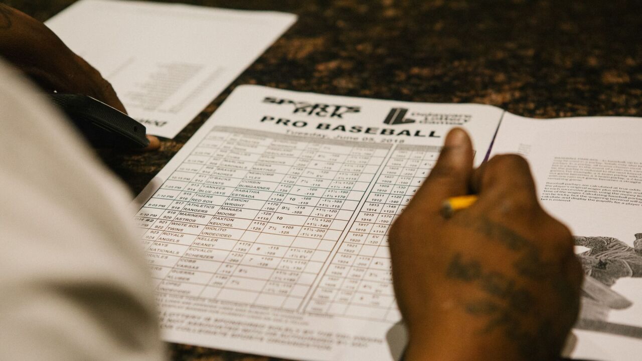 A guest fills out a pick sheet during the launch of full-scale sports betting in Dover, Delaware, U.S., on Tuesday, June 5, 2018.
