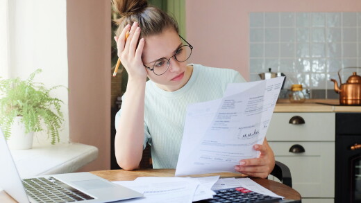Indoor shot of young woman looking at financial statements.