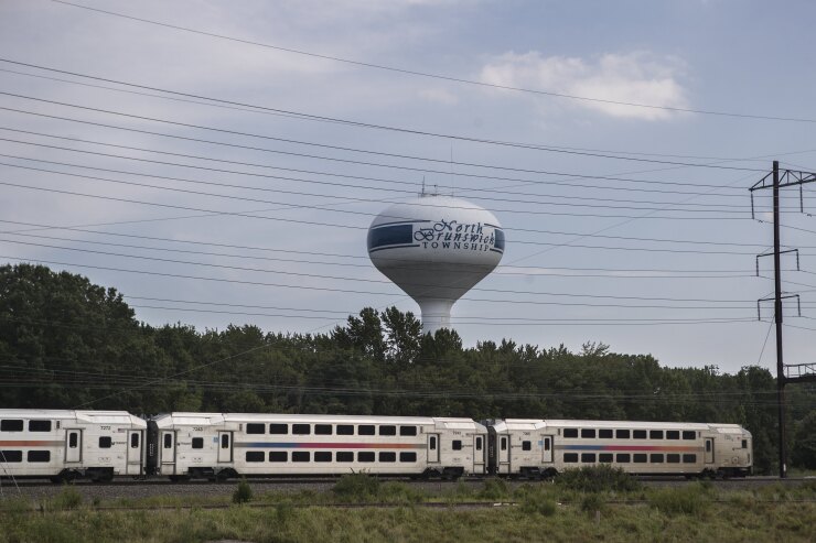 A New Jersey Transit train passes in front of a water tower in North Brunswick, New Jersey, on Aug. 10, 2017.