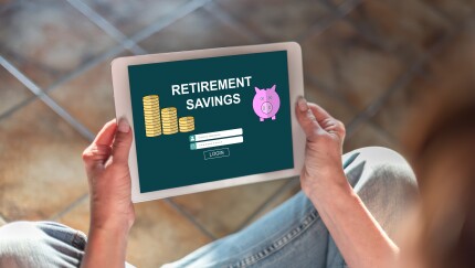 A person holds a mobile device that says "Retirement Savings" on the screen.