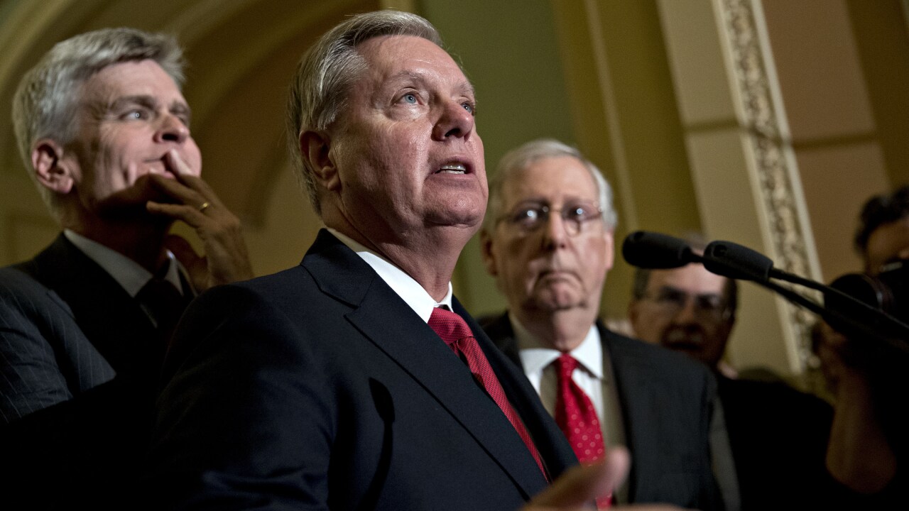 Sen. Lindsey Graham, a Republican from South Carolina, center, speaks as Senate Majority Leader Mitch McConnell, a Republican from Kentucky, right, and Senator Bill Cassidy, a Republican from Louisiana, listen during a news conference after a Republican policy meeting luncheon at the U.S. Capitol.