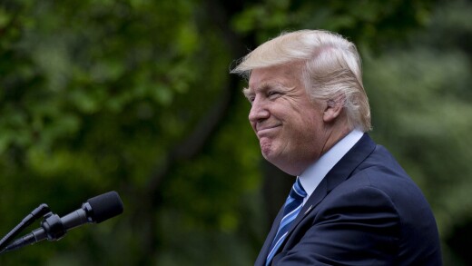 Donald Trump smiles while speaking during a press conference in the Rose Garden of the White House