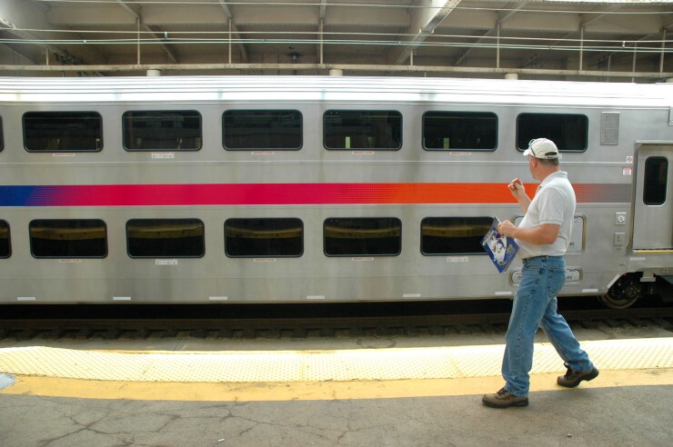 An unidentified man looks at the first of 231 new multi-level rail cars unveiled today at Newark's Penn Station by New Jersey Transit on September 14, 2005.