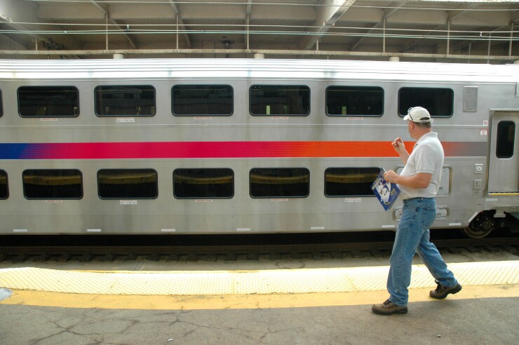 An unidentified man looks at the first of 231 new multi-level rail cars unveiled today at Newark's Penn Station by New Jersey Transit on September 14, 2005. 