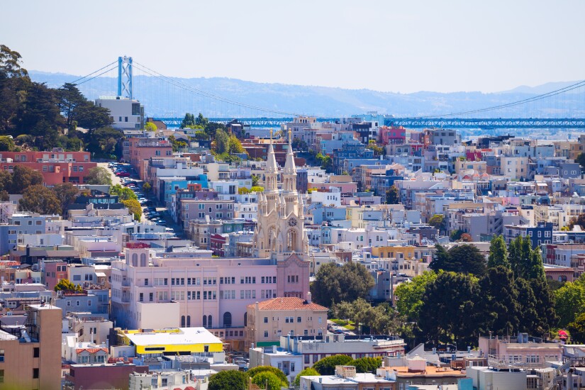 Oakland Bay Bridge over church and Sand Francisco