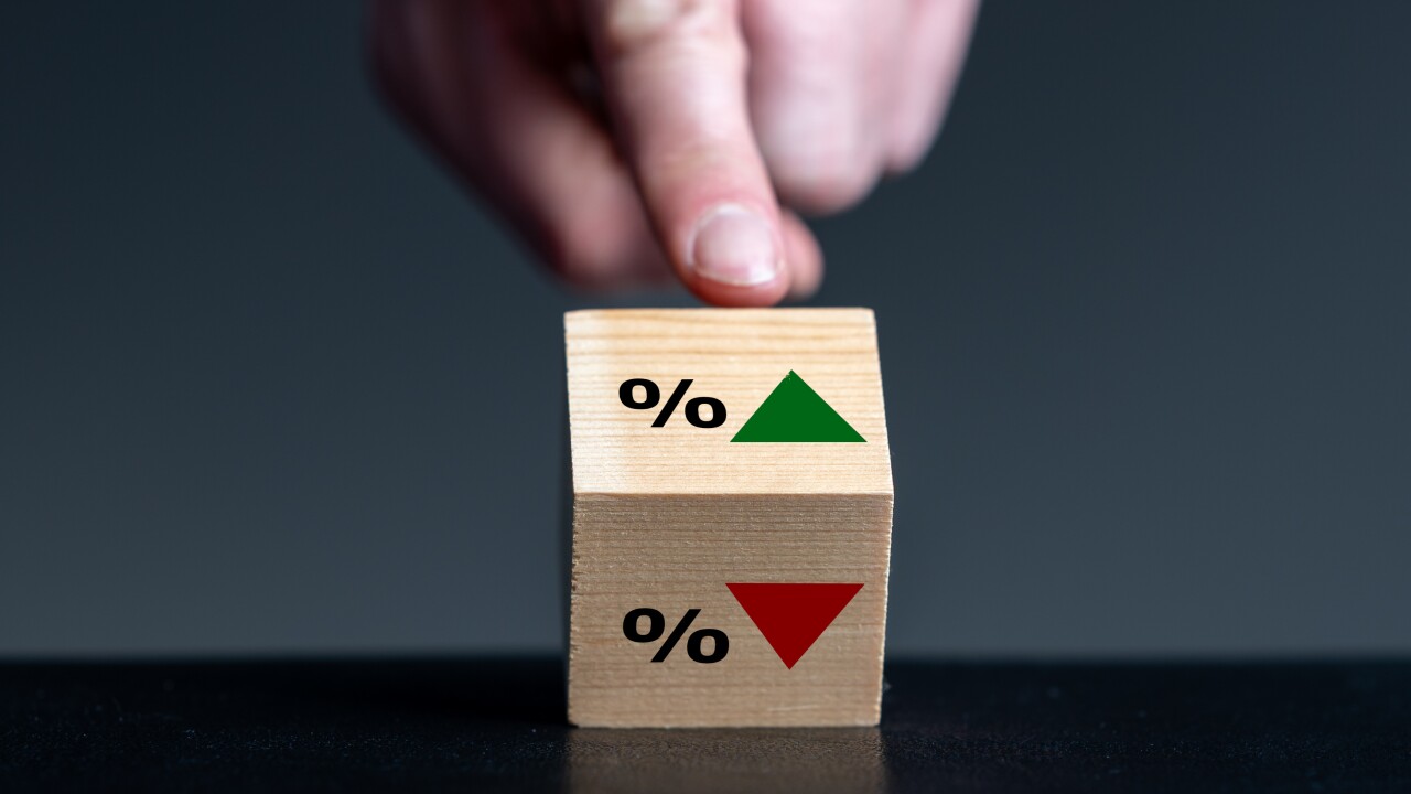 Symbol for the trend of the interest rate. Hand turns wooden cub