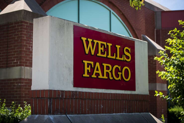 Signage is displayed outside a Wells Fargo & Co. bank branch in Schaumburg, Illinois, U.S., on Tuesday, July 10, 2018. Wells Fargo & Co. is scheduled to release earnings figures on July 13. Photographer: Christopher Dilts/Bloomberg