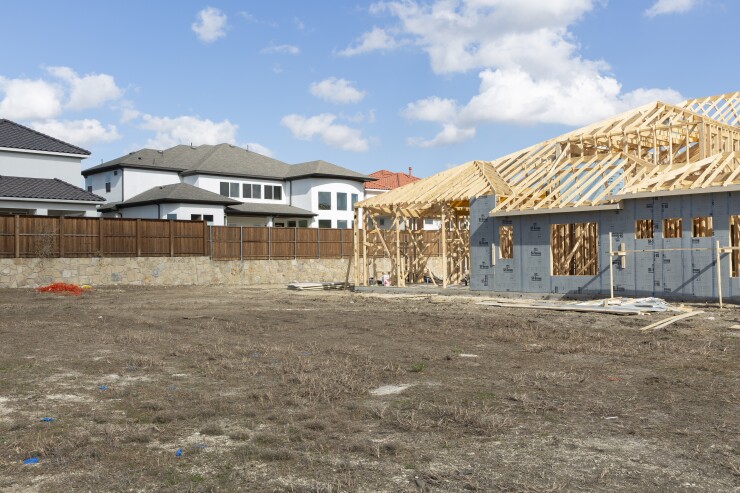 A house under construction stands near new homes at the Lexington Country development in Frisco, Texas, U.S., on Saturday, Nov. 17, 2018