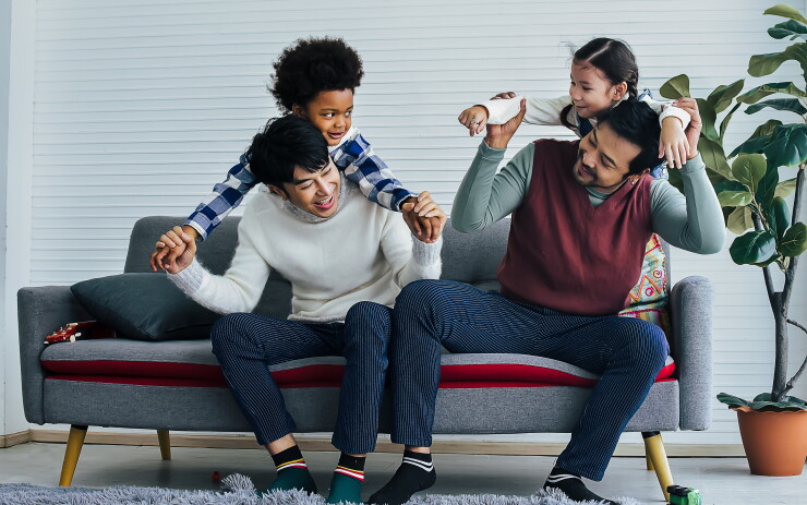 Two fathers playing with their children.