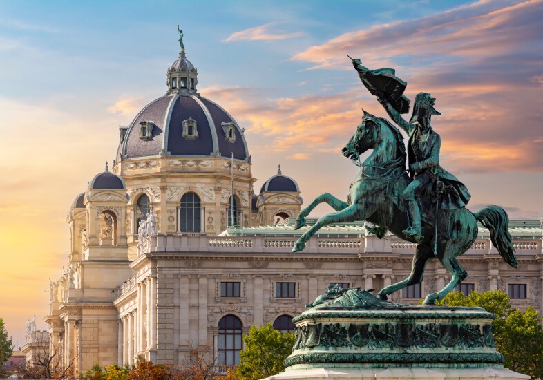Statue of Archduke Charles on Heldenplatz square and Museum of Natural History dome in Vienna, Austria.