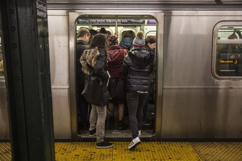 Commuters stand in a crowded L train subway car at the Bedford Avenue station in the Brooklyn borough of New York, U.S., on Thursday, Dec. 21, 2017.