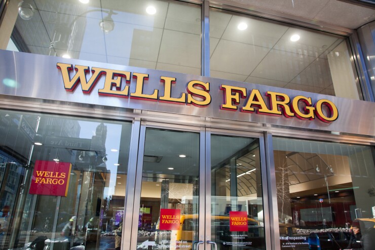 Signage is displayed at a Wells Fargo bank branch in New York.