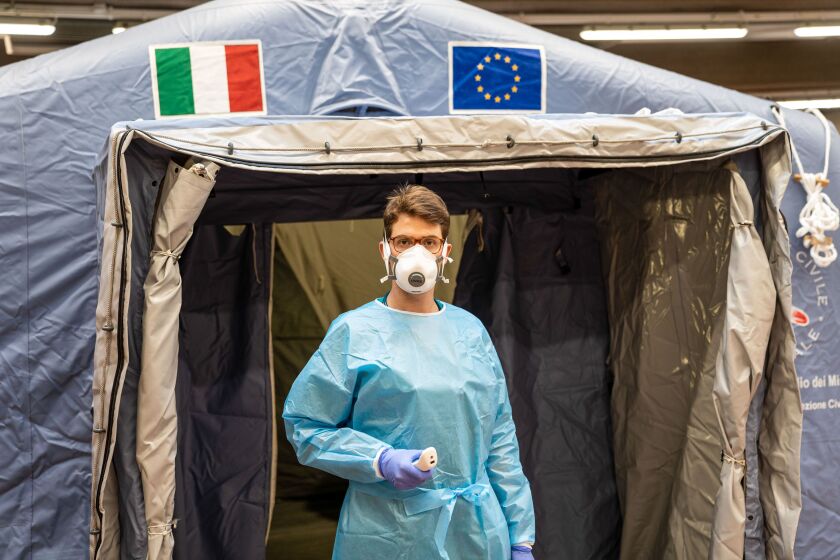 A medical worker wearing a protective face mask in Turin, Italy
