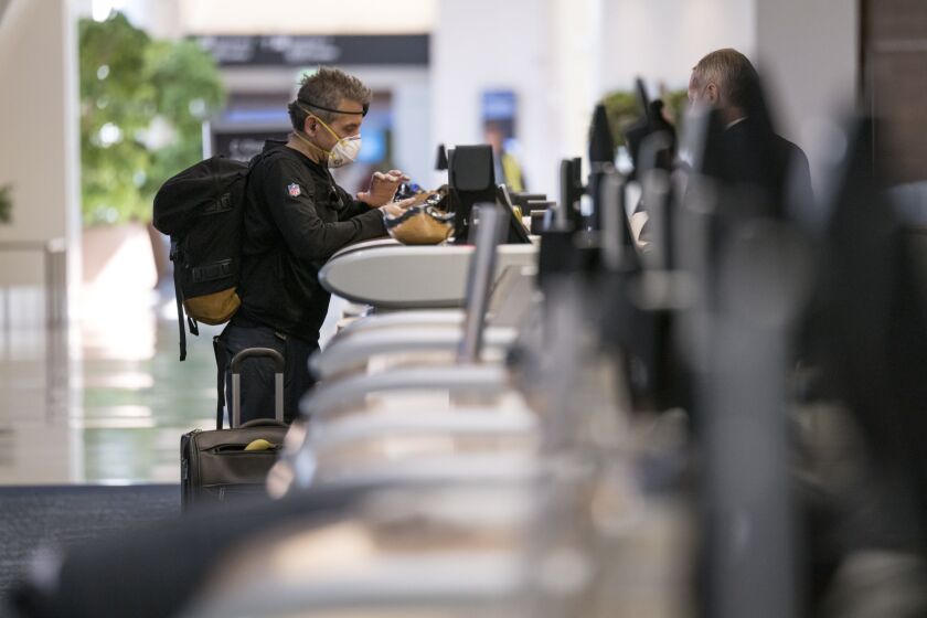 A traveler checks in at the Delta Air Lines counter in San Francisco on April 2. Photographer: David Paul Morris/Bloomberg