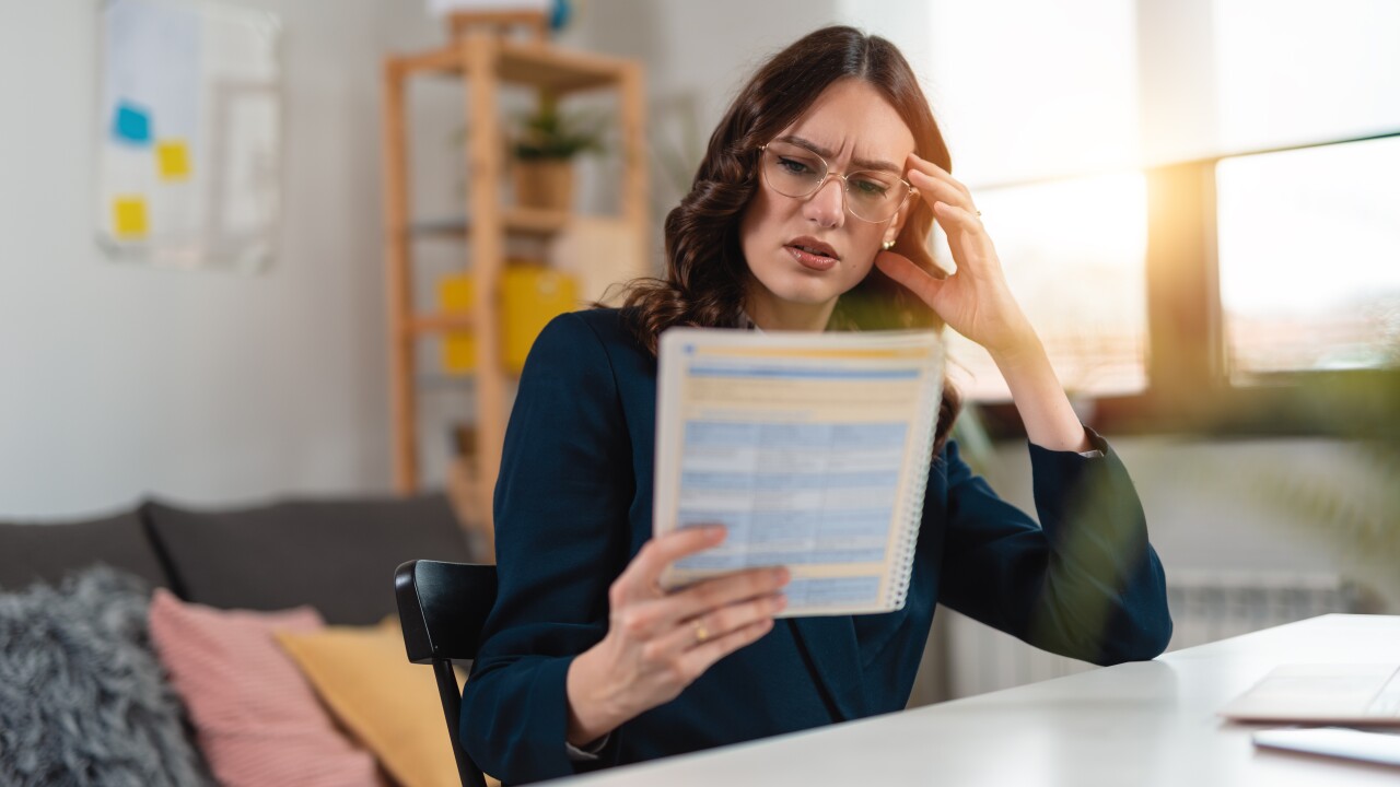 Woman looking at paper frustrated