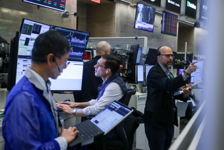 Traders work on the floor at the New York Stock Exchange. Photographer
