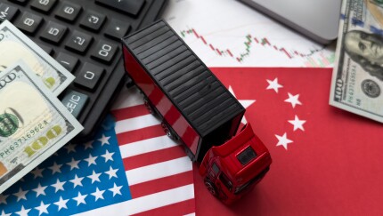 China flag and US flag on china map and hand holding computer chip on background.