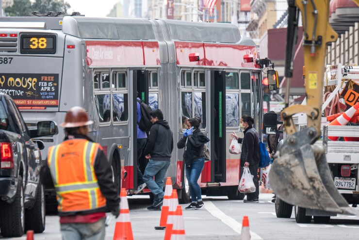 Passengers board a transit bus in San Francisco