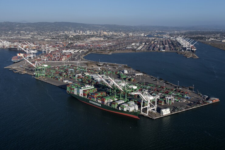 An Evergreen Marine Corp container ship sits docked at the Port of Oakland in this aerial photograph taken above Oakland, California, U.S., on Monday, Oct. 5, 2015.