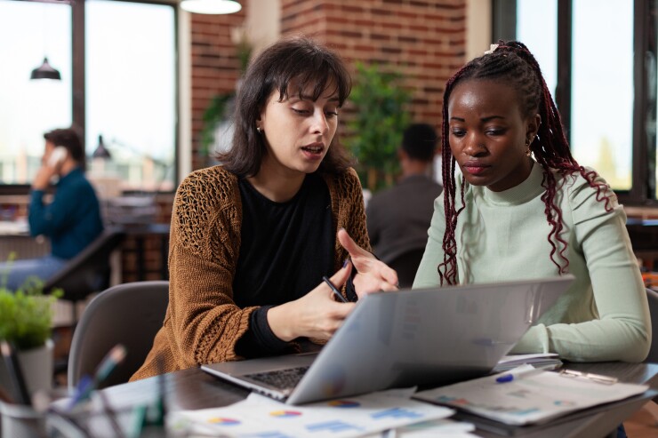 Two women working together at a computer