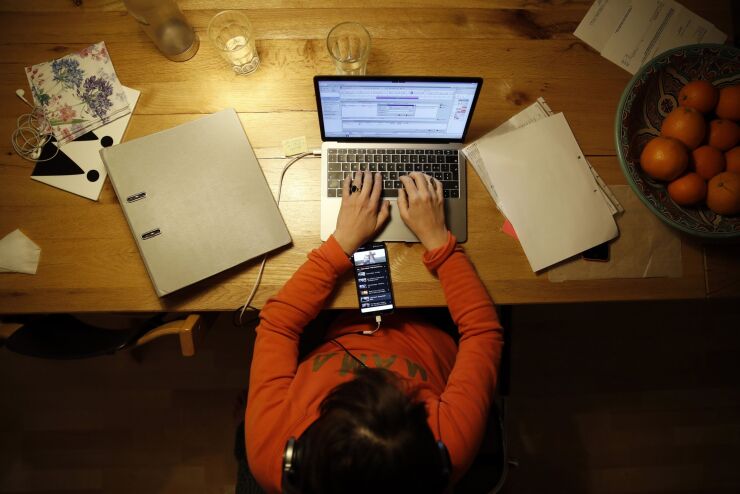 A person works at a laptop computer at home in an arranged photograph taken in Bern, Switzerland