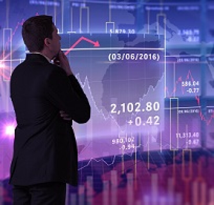 Person looking at data graphics on an electronic board.