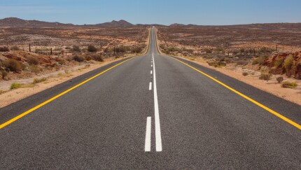 A two-way stretch of road that goes into the distance