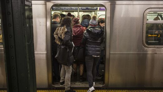 Commuters stand in a crowded L train subway car at the Bedford Avenue station in the Brooklyn borough of New York, U.S., on Thursday, Dec. 21, 2017.