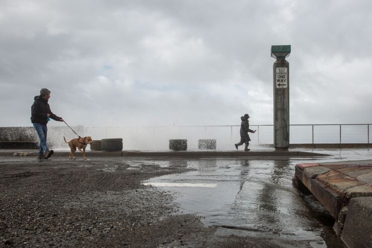 Waves break over the seawall in Pacifica, California, US, on Tuesday, Jan. 10, 2023. California faces more drenching rain, as concerns about drought have been replaced by fears of flooding that’s killed at least 14 people, closed highways and sent residents fleeing for their lives. Photographer: Shelby Knowles/Bloomberg