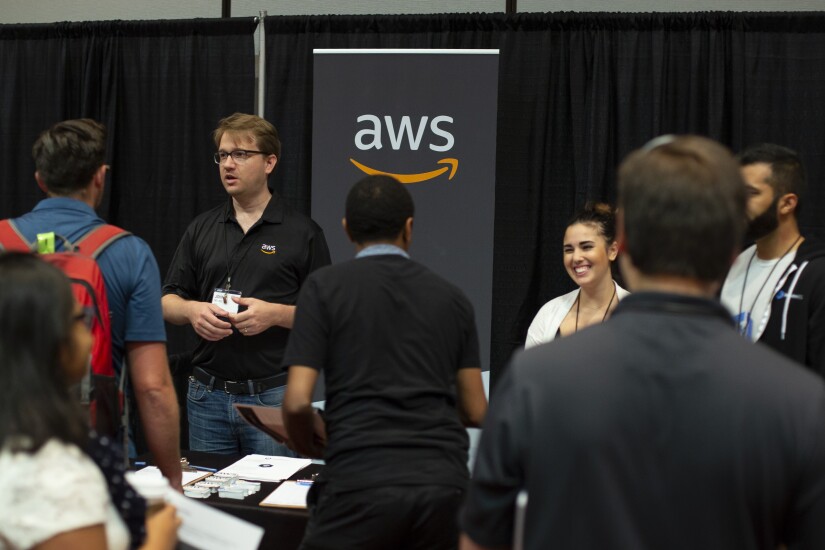 Amazon Web Services logo and people around it
