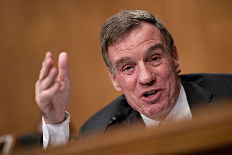 "We've created this cliff effect" on who is eligible, said Sen. Mark Warner, D-Va., adding that he shares concerns of others about how long it is taking the Fed to launch the Main Street program.