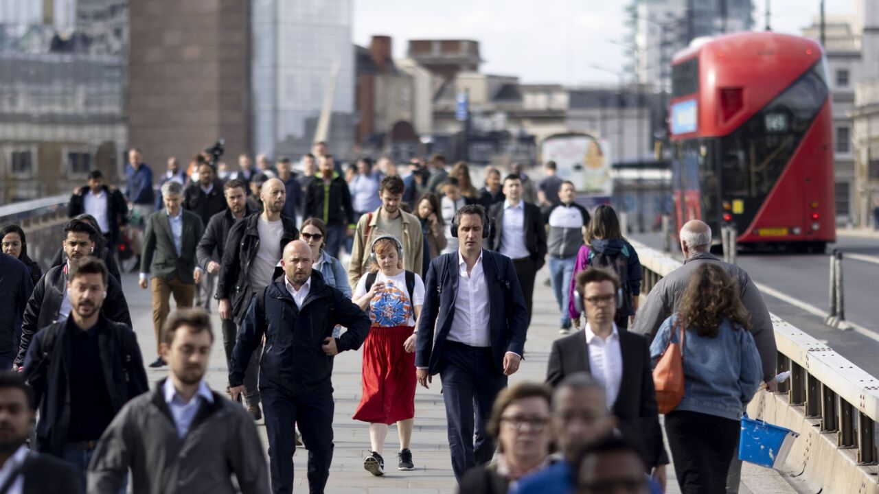 Morning commuters on London Bridge in the City of London, UK, on Monday, May 16, 2022. The Office for National Statistics (ONS) will release the latest UK Labor Market Statistics on Tuesday. Photographer: Jason Alden/Bloomberg