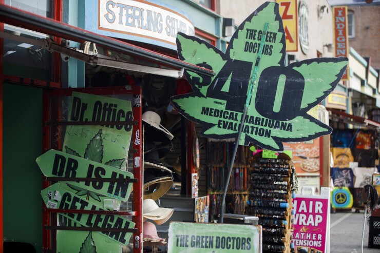 Signage advertising "The Green Doctors $40 Medical Marijuana Evaluations" are displayed in the Venice Beach neighborhood of Los Angeles.