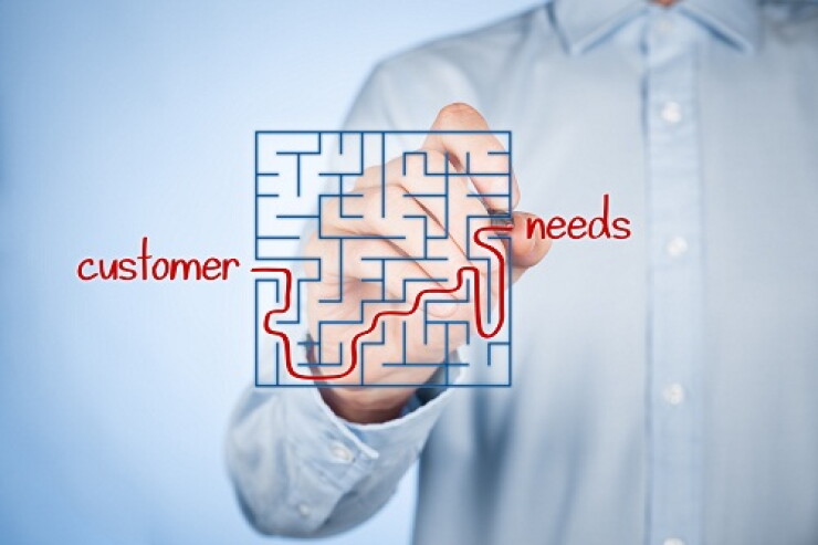 Man drawing a red line on a maze to travel from customer to their needs.