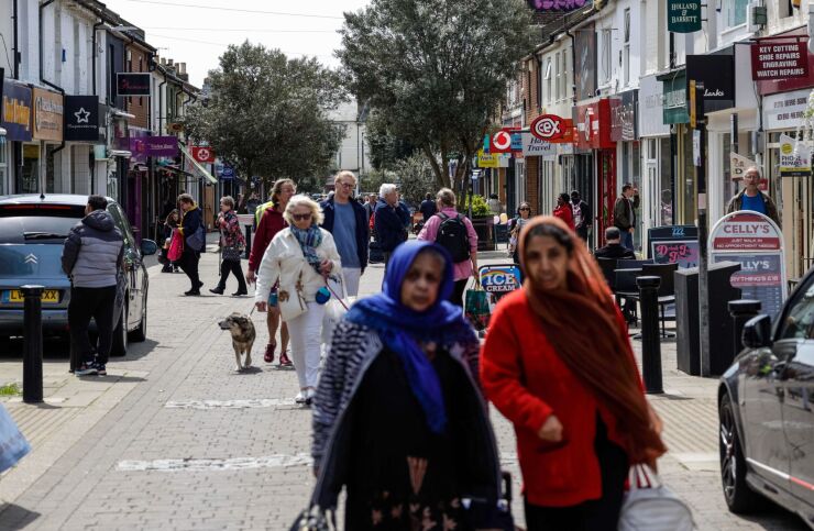 Shoppers walk along a high street in Hove, UK, on Monday, May 15, 2023. The upcoming batch of jobs data, due on Tuesday, May 16, is likely to show price pressures in the economy remain way too high for the Bank of England to tolerate. Photographer: Carlos Jasso/Bloomberg
