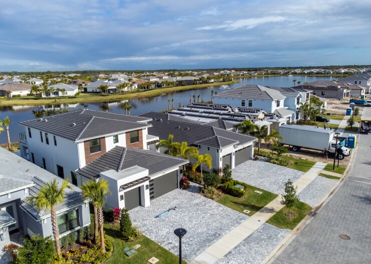 An aerial view of several homes near water