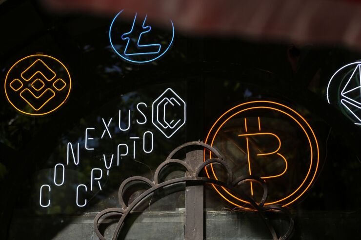 The logos of Bitedance, Litecoin, Bitcoin and Ethereum, left to right, at the Conexus Crypto currency exchange office in Tbilisi, Georgia, on Monday, July 25, 2022. A buzz is building in crypto-investor circles and on Twitter about Bitcoin’s stealth July rally, which has beleaguered investors starting to ponder whether the largest digital asset has found a bottom. Photographer: Valeria Mongelli/Bloomberg