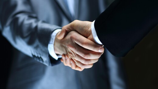 Handshake - Hand holding on black background