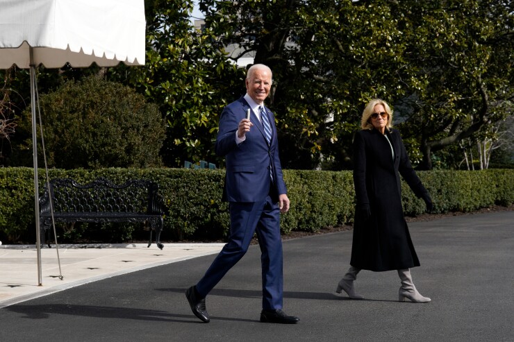 President Joe Biden, left, and First Lady Jill Biden walk on the South Lawn of the White House before boarding Marine One in Washington, D.C.
