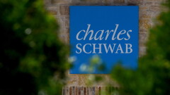 Charles Schwab sign blue with trees Bloomberg April 22, 2019