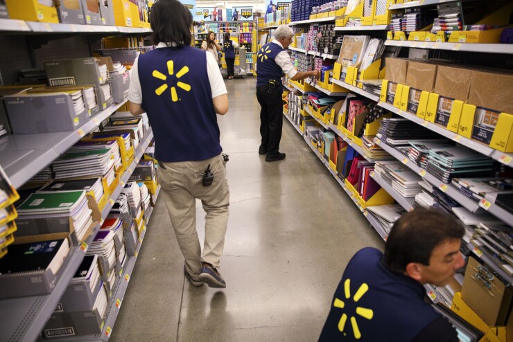 Employees restock shelves of school supplies at a Wal-Mart Stores Inc. location in Burbank, California.