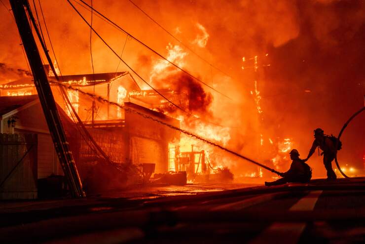 Firefighters battle flames during the Palisades Fire in Los Angeles on Jan. 7, 2025.