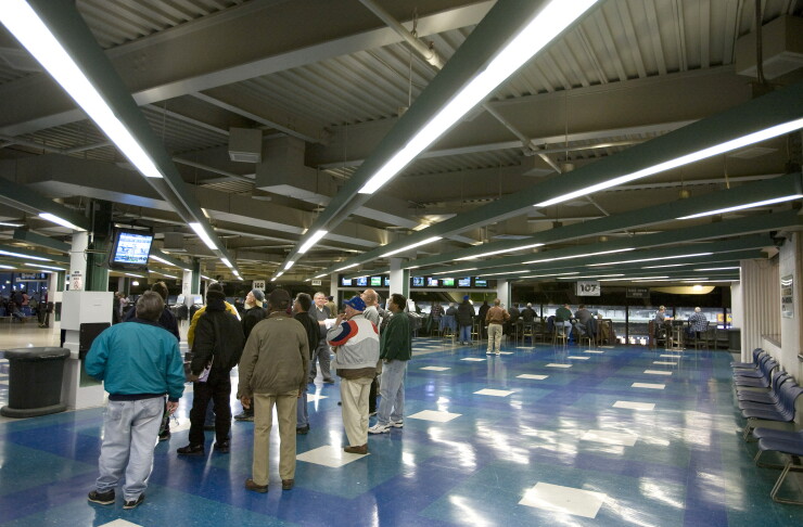 Visitors watch a simulcast horse race at the Meadowlands Racetrack in East Rutherford, New Jersey, on Saturday, Jan. 5, 2008.