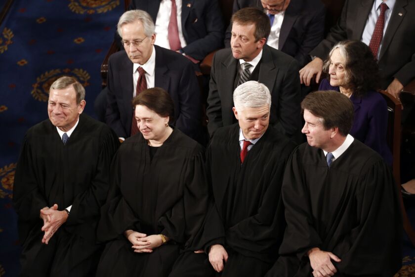 Several justices, including Chief Justice John Roberts, far left, suggested that it could be problematic to establish a new standard for presidential firings since that standard could also be challenged in court.