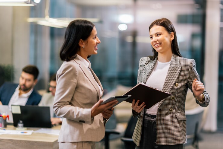 Two women talking in office