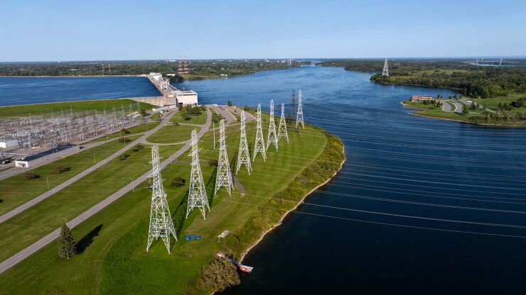 Electricity transmission lines in front of a dam
