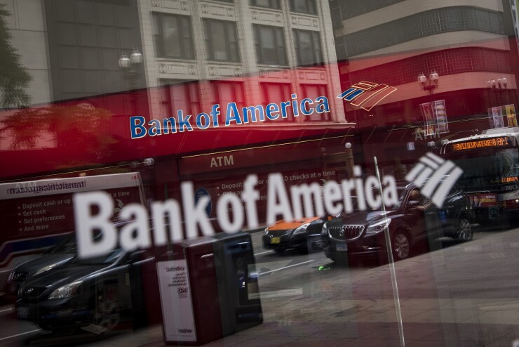 Vehicles are reflected in the window of a Bank of America branch in Chicago.