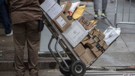 A United Parcel Service Inc. (UPS) driver pushes a trolley with Amazon boxes during a delivery in New York, U.S., on Tuesday, Oct. 13, 2020. Amazon.com Inc.'s two-day Prime Day sale kicks off on Tuesday and is expected to give the world's largest e-commerce company an early advantage over brick-and-mortar rivals still contending with pandemic-spooked consumers wary of battling Black Friday crowds. Photographer: Victor J. Blue/Bloomberg